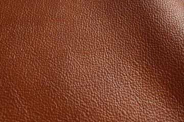 Fototapeta premium Reddish brown grained leather texture close-up