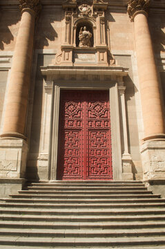Huge, red cathedral door in Salamanca. Spain.