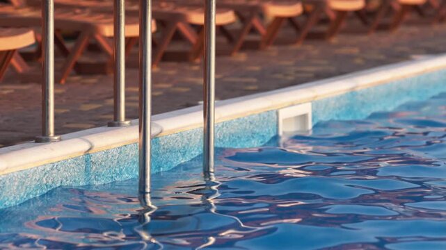 Top view of swimming pool with clear water on vacation on sunset background