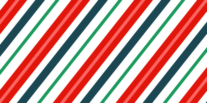 Festive pattern of Christmas candy canes. Christmas candy cane background with red and green diagonal stripes. Winter wrapping paper.