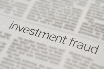 Fototapeta premium Newspaper print page showing investment fraud text for finance security and risk analysis