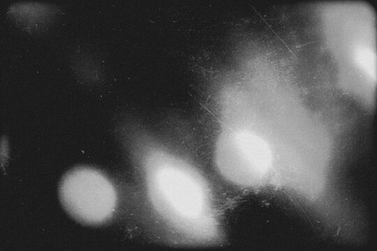 retro film overlay effect with scratch dust and light leaks, retro grain noisy film distressed texture light leak flare on black background,black and white abstract light background