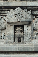 Obraz premium Ancient Prambanan Temple Guardian Statue and Stone Relief Detail