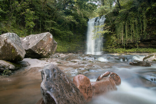 Sgwd isaf clun-gwyn waterfall flowing through brecon beacons forest