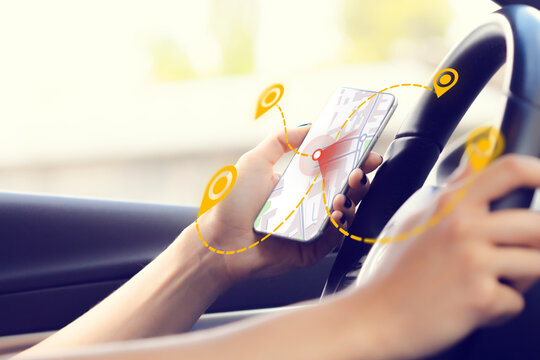 Person using a smartphone for taxi location on a map while driving