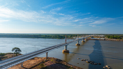 Fototapeta premium High angle drone shot of a landmark bridge connecting two nations, emphasizing engineering design, mobility, and economic progress in Southeast Asia.