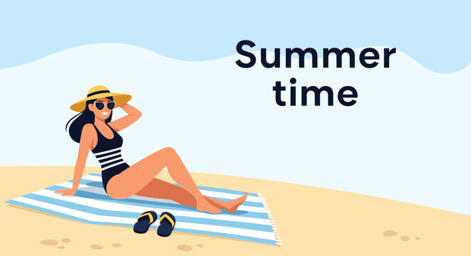 Summer vacation concept showing a relaxed woman in a swimsuit and sunhat sitting on a beach towel on the sand.