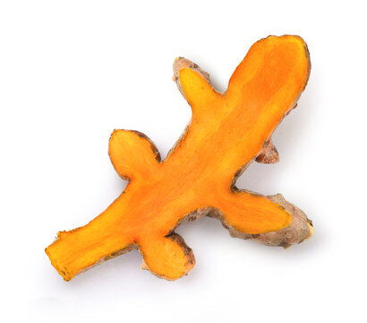 Turmeric root half sliced isolated on white.