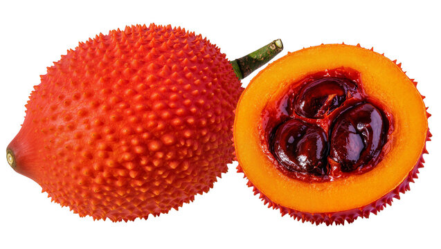 Spiky orange Gac fruit whole and halved, showing seeds