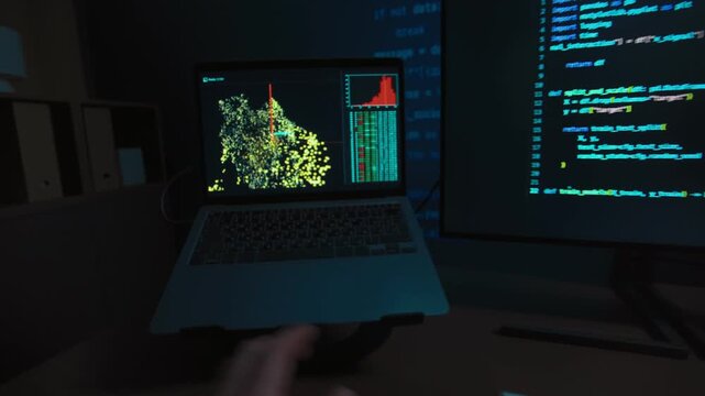 First person view of a programmer hands typing on a keyboard at night, two monitors displaying code and data science visualizations on dark desk, works on a machine learning or data science. POV