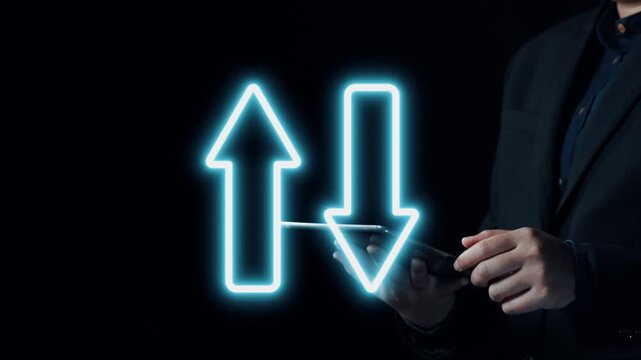 A businessman interacts with a smartphone while colorful neon arrows represent quality and cost factors, illustrating investment and economic strategies in a professional context. Qubit