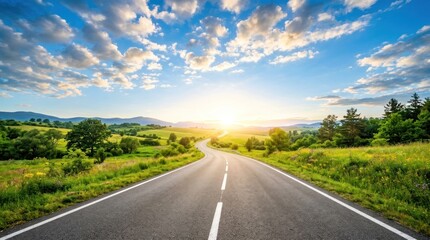 Fototapeta premium A sunny road stretches into the distance, winding through a lush green valley. The road is asphalt, with white lane markings.