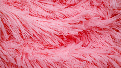 Obraz premium Fluffy pink fabric drapes across a flat surface in a close-up view showing soft textures and strands