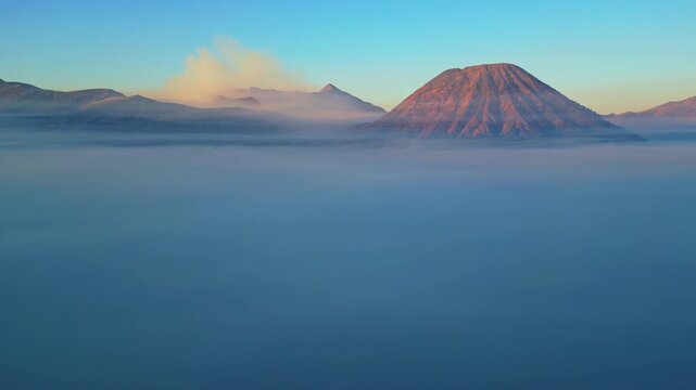 Breathtaking high angle panorama of iconic Mount Bromo volcano &ndash; Epic surreal volcanic desert with active smoking cone in Java Indonesia, commercial stock footage background for advertising