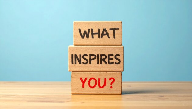 Stacked Wooden Blocks With Text What Inspires You Question Mark On Wooden Desk Against Blue Background
