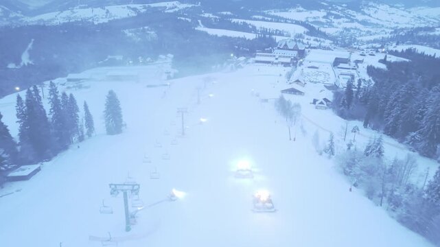 Serene Ski Slope At Dawn. Calm Dawn Scene Over Empty Ski Region With Lifts And Snowcovered Trails