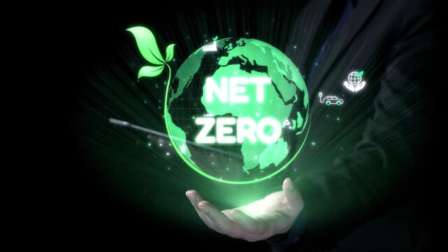 A hand supports a glowing globe with "Net Zero" text, symbolizing goals for a sustainable future. Surrounding icons illustrate eco-friendly technology and practices. Qubit