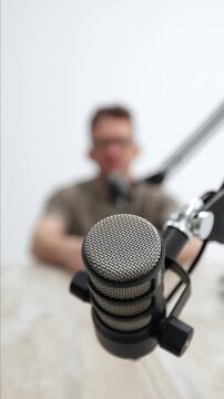 Highgrade Male Voice Artist Performing In Sleek Minimalistic Studio Using Advanced Equipment