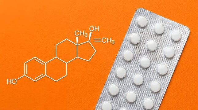 White medication pills in a silver blister pack placed next to a chemical structural formula of testosterone drawn on a vibrant orange surface representing medical hormone therapy research