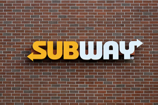 Subway sign on the exterior of one of its locations in suburban Chicago. Subway is a multi-national fast food restaurant franchise that primarily sells submarine sandwiches and wraps.