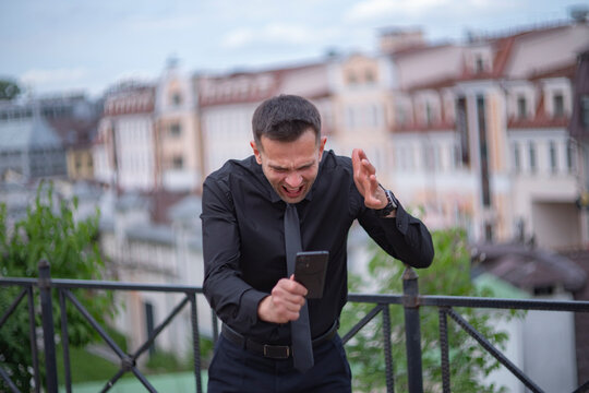 Aggressive businessman gesticulating and screaming at phone with copy space