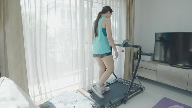 A person engaged in a treadmill workout indoors, surrounded by natural light from windows, promoting a healthy lifestyle and fitness routine.