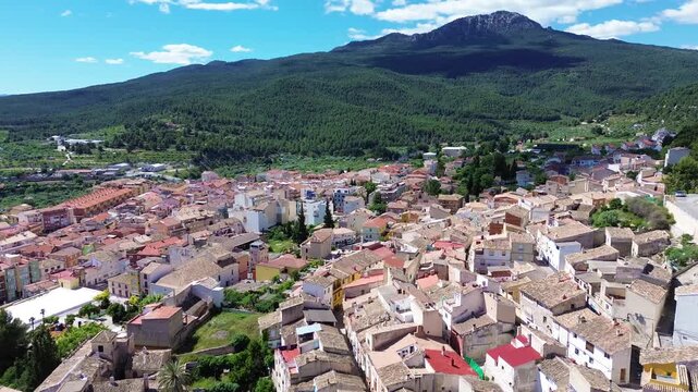 Aerial drone view of historic Calasparra town in southern Spain featuring old town houses medieval castle mountain landscape traditional architecture travel destination and scenic urban panorama under