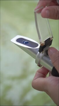 4K Salinity Check in Fish Hatchery Tank &ndash; Aquaculture Worker Monitoring Water Quality for Sustainable Barramundi Fry Farming