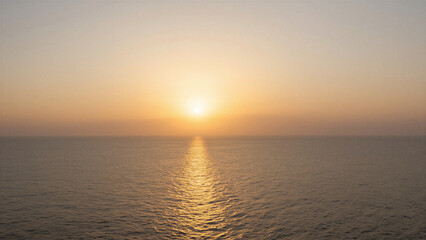 Obraz premium Golden sun dips low over calm ocean waters. Glistening waves ripple gently toward horizon line. Soft gradient sky fades from amber to pale blue. Serene moment invites quiet contemplation and peace