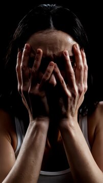 Slow motion close up, a frightened woman instinctively throwing her hands up to protect her face, cringing in sudden pure absolute terror, sharp dynamic lighting, 4k.