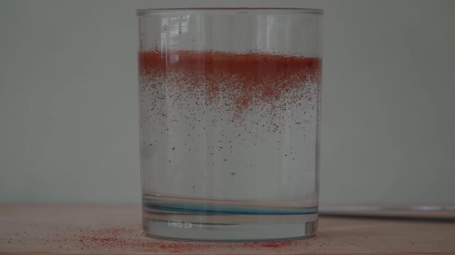 Close-up footage of smoked paprika spice with rich red texture and floating particles in soft lighting. Detailed macro food background with natural movement, perfect for culinary visuals, seasoning co