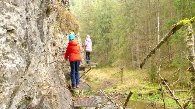 Two little beautiful girls walk in Slovak Paradise. Slovak Paradise (Slovensky raj) is mountain range in eastern Slovakia, part of Spis-Gemer Karst, located between towns of Spisska Nova Ves.