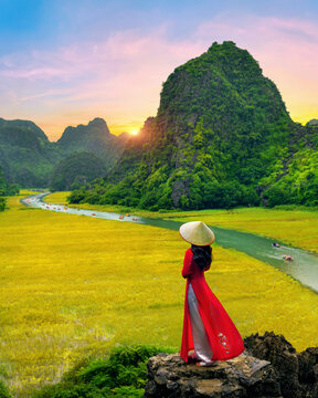 Asian woman wearing Vietnam culture traditional at Tam coc, Vietnam.