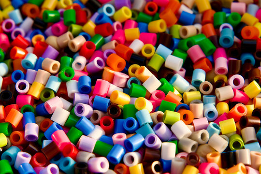 Colorful perler beads close up. Multicolored plastic fuse beads texture with shallow depth of field. Creative craft material.