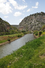 Fototapeta premium Scenic landscape of Mavi Bogaz Canyon with a flowing river and green banks.