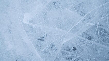Fototapeta premium Frozen lake surface displaying intricate ice patterns and cracks forming a beautiful abstract design