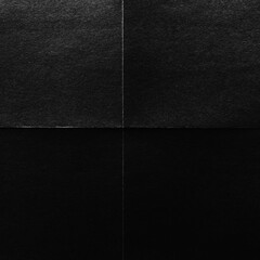 Fototapeta premium A textured black square divided into four equal sections.