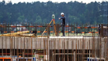 Worker stands atop unfinished concrete structure © I