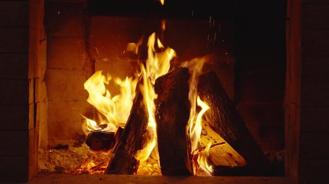 Wood burning in a cozy fireplace at home 4k footage