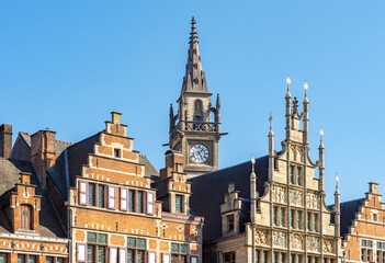 Obraz premium Medieval architecture of Graslei quay at Lys (Leie) river with Clock tower of former Post Office, Ghent, Belgium