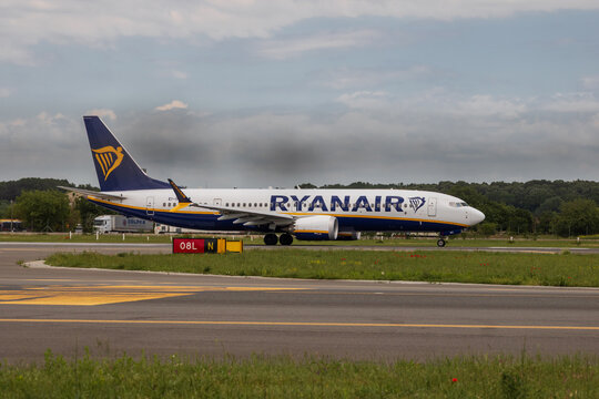 Ryan Air commercial passenger airplane taxiing on the asphalt tarmac and takeoff at an airport runway in Romania