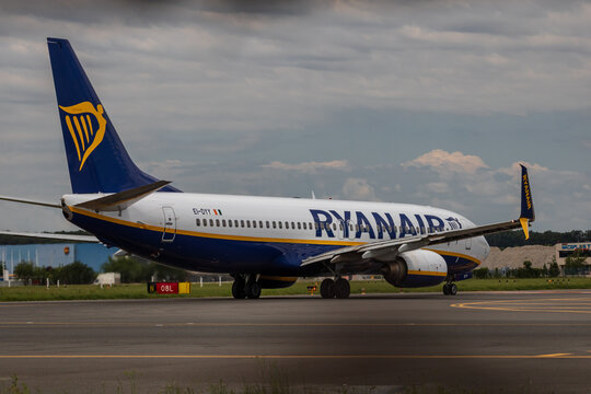 Ryan Air commercial passenger airplane taxiing on the asphalt tarmac and takeoff at an airport runway in Romania