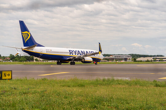 Ryan Air commercial passenger airplane taxiing on the asphalt tarmac and takeoff at an airport runway in Romania