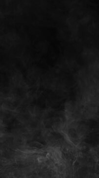 Thick gray smoke filling frame on black background vertical abstract fog backdrop