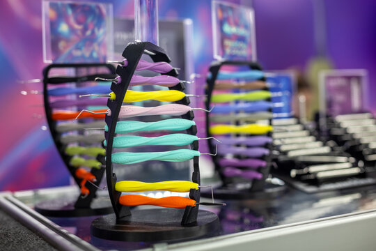 Colorful Dental Tools Displayed in Clinic. Close-up of colorful dental instruments arranged on stands in a modern clinic or dental supply showroom.