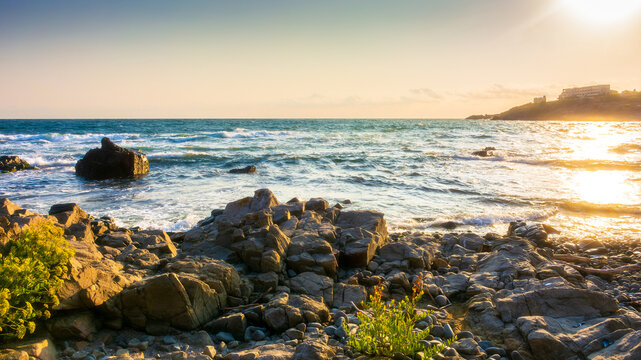 rocky beach at the black sea. clear blue sky on a sunny morning over the sea. summer vacation background. beautiful view with stone and calm waves for travel and relax on the beach. bay of sozopol