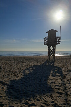 Lifeguard tower silhouette on Puerto de Sagunto beach in Valencia Spain
