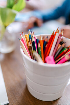 Colored pencils in a cup at adult vision board workshop or art class