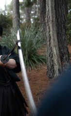 Naklejka premium Close-up cinematic scene of katana blades slowly crossing during a samurai confrontation in a forest setting. Traditional Japanese swordsmanship captured with dramatic tension, historical atmosphere, 