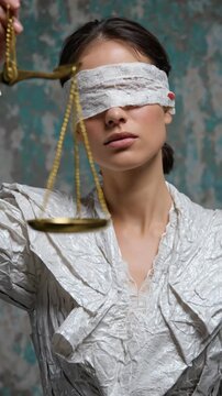 A blindfolded personification of Justice, symbolizing impartial judgment, ethical balance, legal fairness, equality, and wisdom through the scales of law